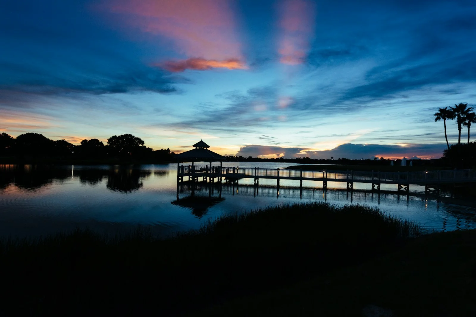 A lakeside boardwalk and pavilion at dusk in Tradition, Port St. Lucie